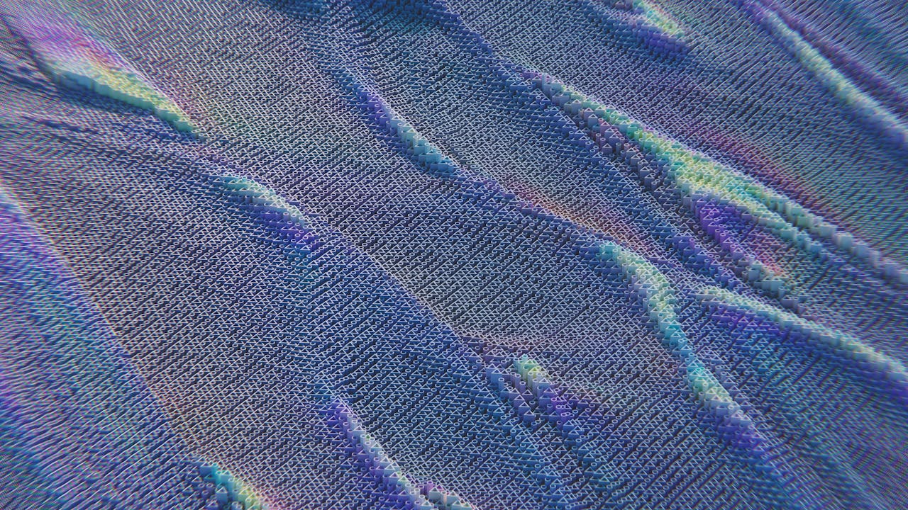 services-02 Colorful abstract pattern resembling digital waves with intricate texture in blue and purple hues.